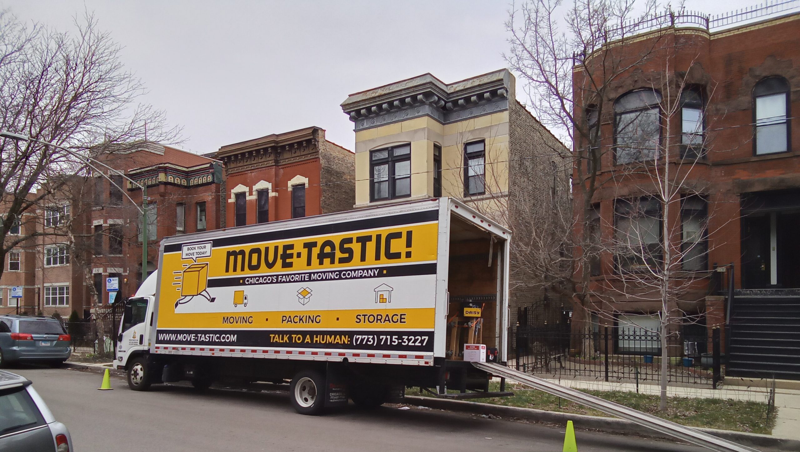 Move-tastic moving truck parked on a residential Chicago street
