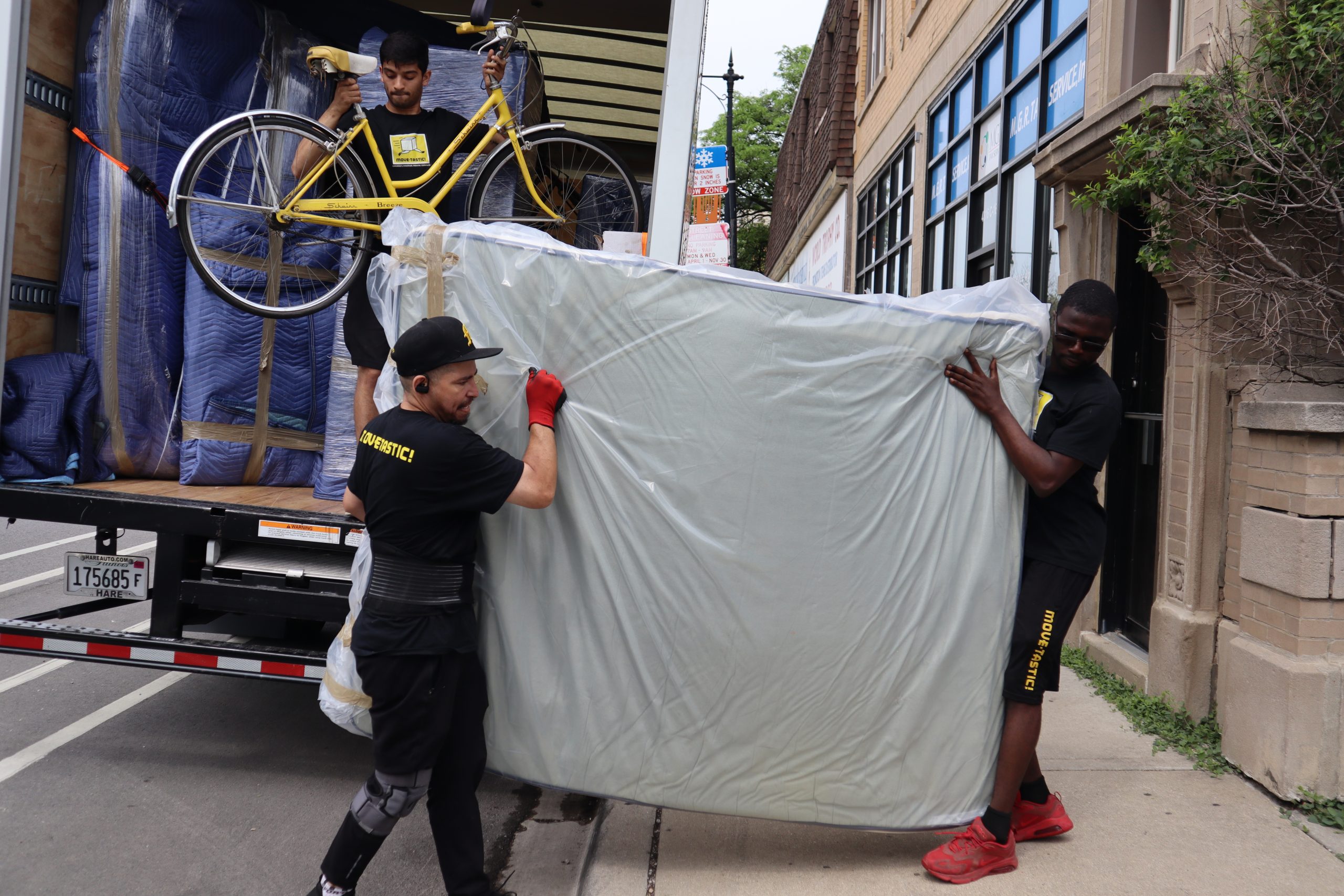 Two movers carrying a mattress