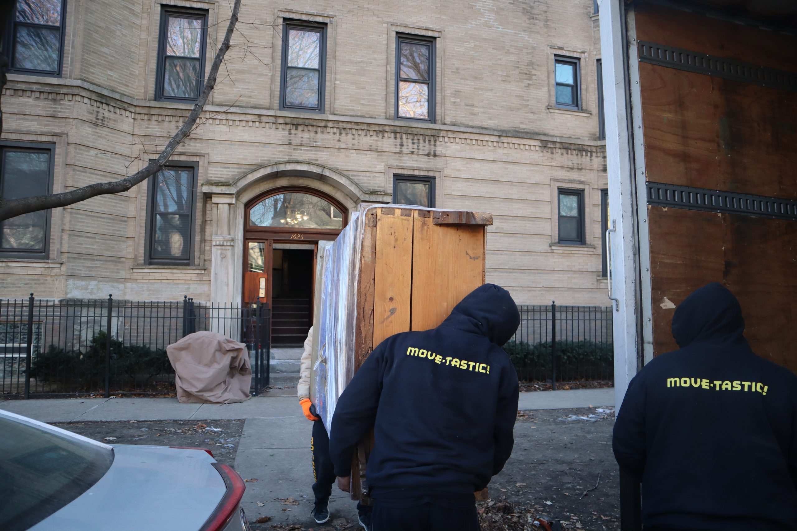 Movers walking into apartment building