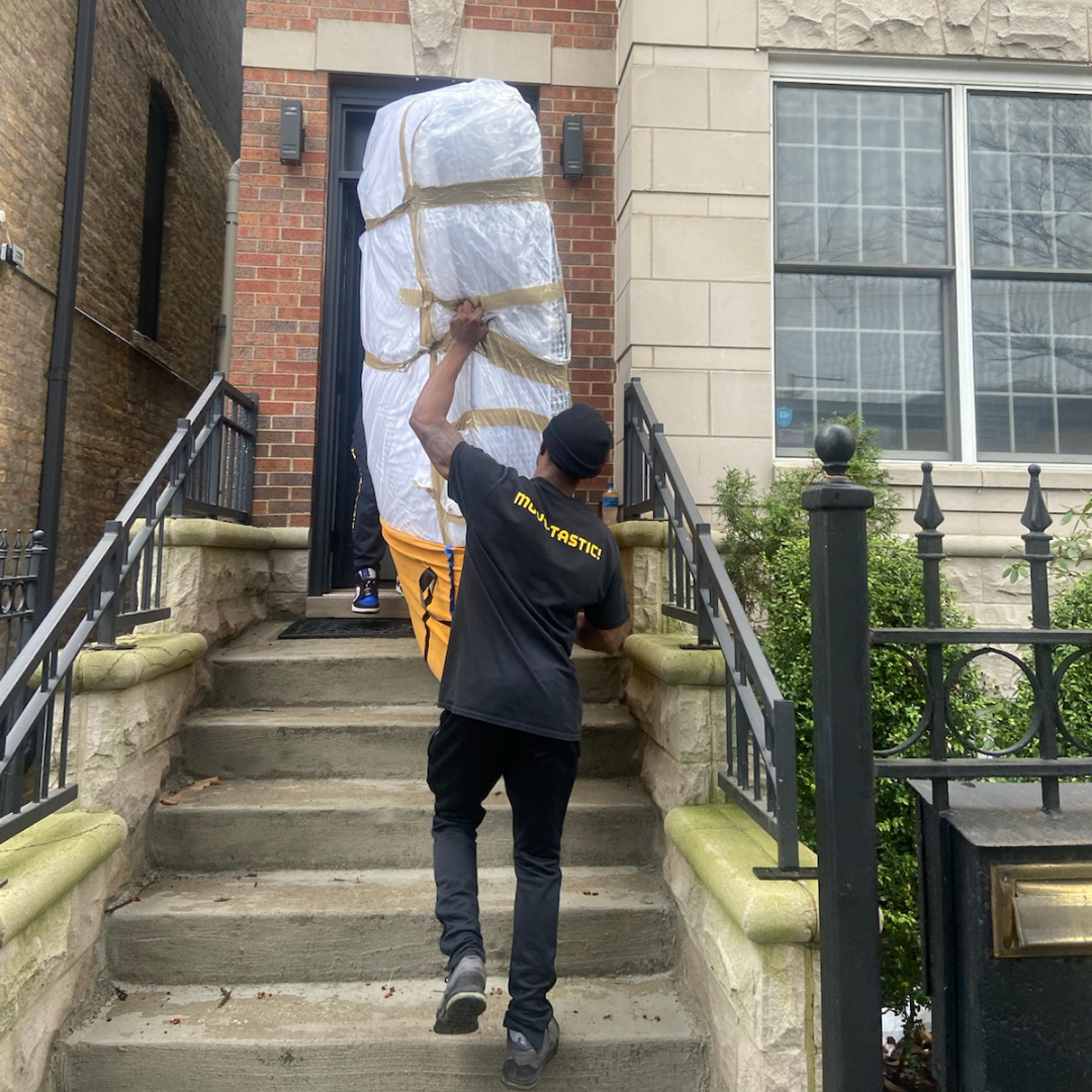 Movers carrying a mattress