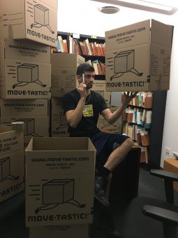 A mover considering how to pack books correctly